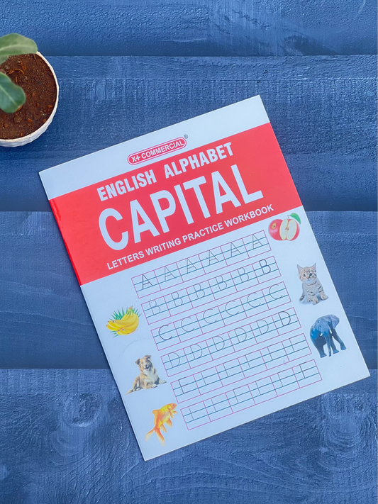 Children's workbook on a blue surface with a plant in the corner