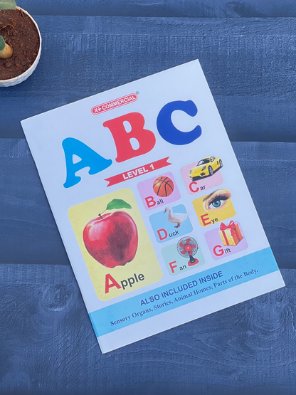 Children's book titled 'ABC' on a blue textured surface with a small plant.